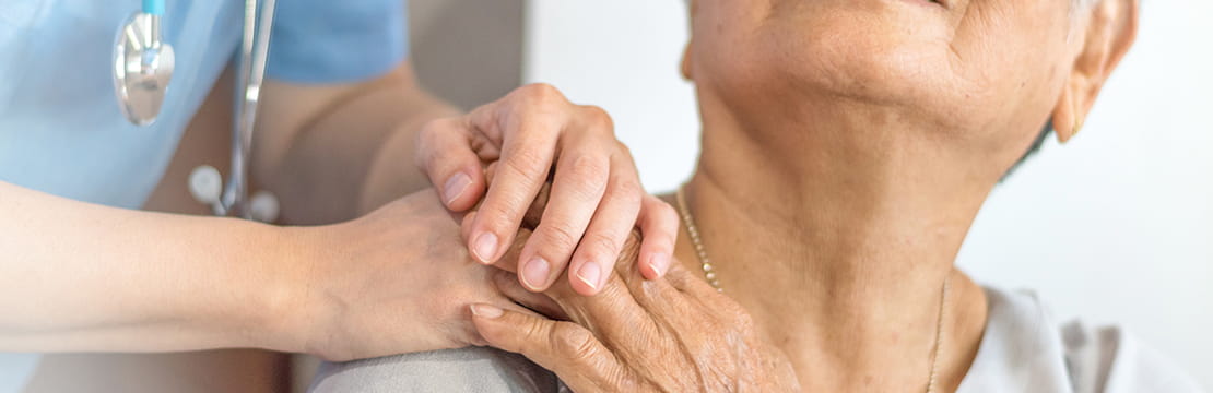 Doctor physician hand on happy elderly senior patient